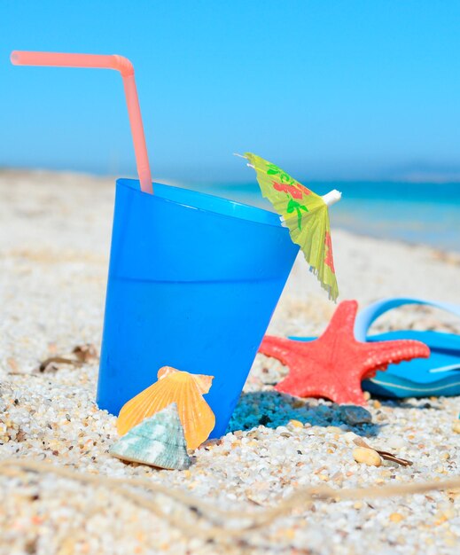 Blue drink with sandals on a tropical shore