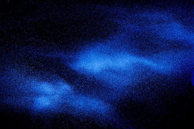 Blue dust explosion on black background