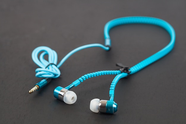 blue earphone and cable line like zipper