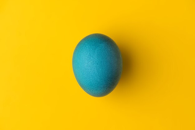 Blue easter egg on yellow background Colors of the flag of Ukraine Stop war Stand with Ukraine