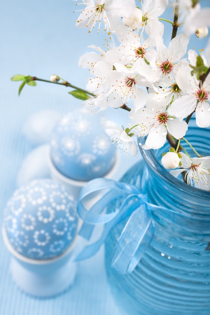 Blue Easter eggs and cherry blossoms, space