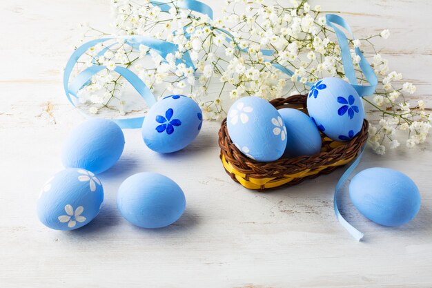 Blue Easter eggs in a small wicker basket