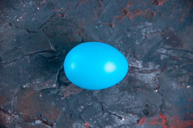 Blue egg on dark mix colors distressed background with free space