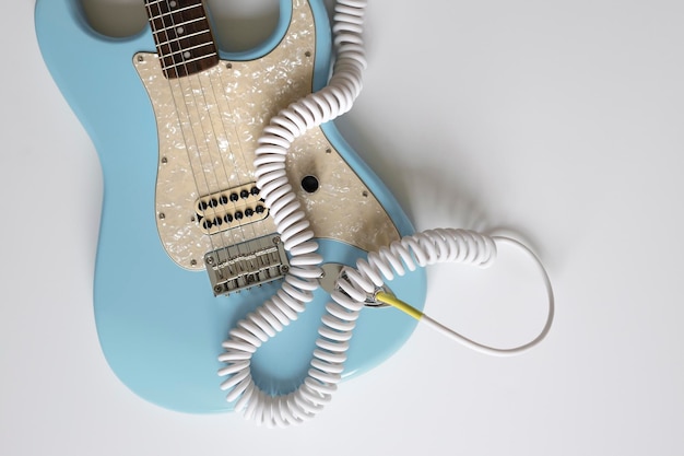 Blue electric guitar with white wire