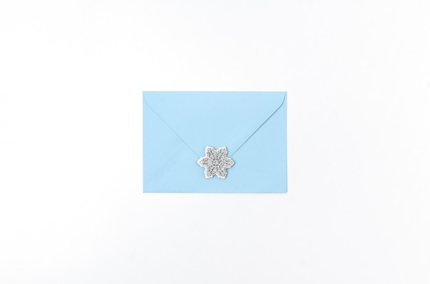 Photo blue envelope with snowflakes isolated