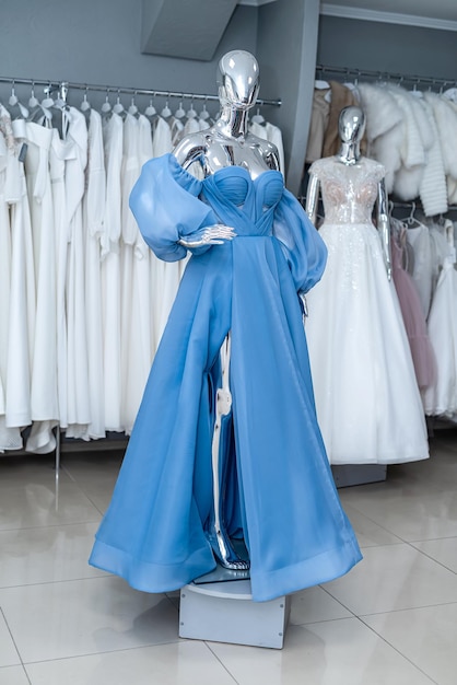 Blue evening dress on mannequin for party bridesmaid wedding in bridal shop fashion concept