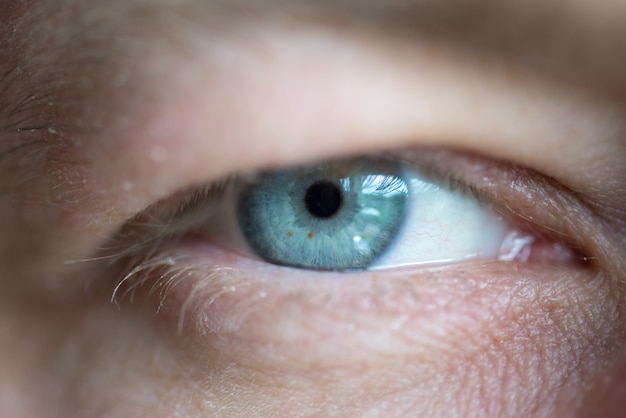 Blue eye men close up macro background