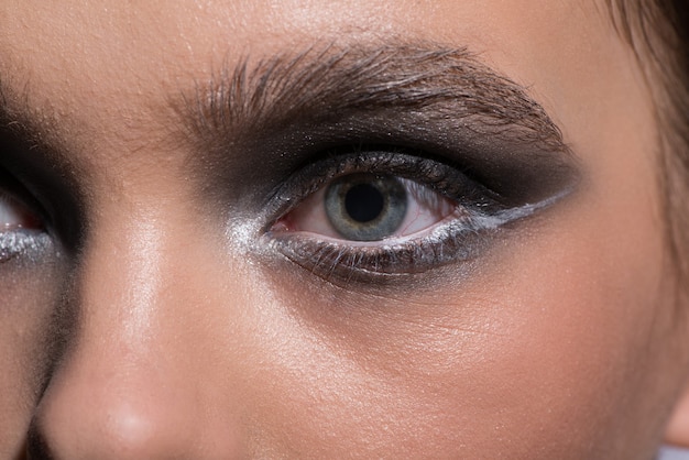 Blue female eyes with modern fashionable makeup. Close-up