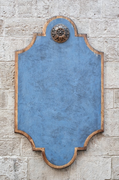 Blue figured plaque on a brick wall