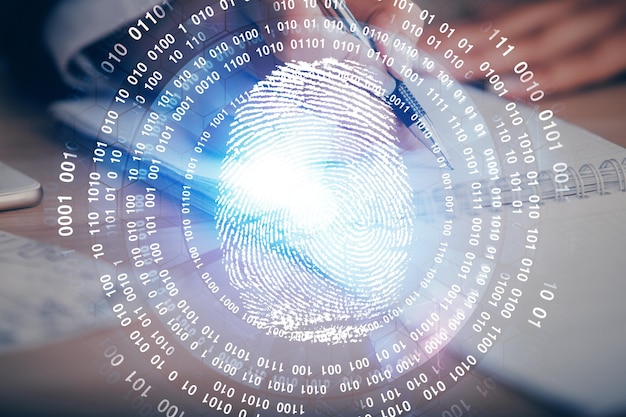 Blue fingerprint hologram over womans hands taking notes background Concept of protection Double exposure