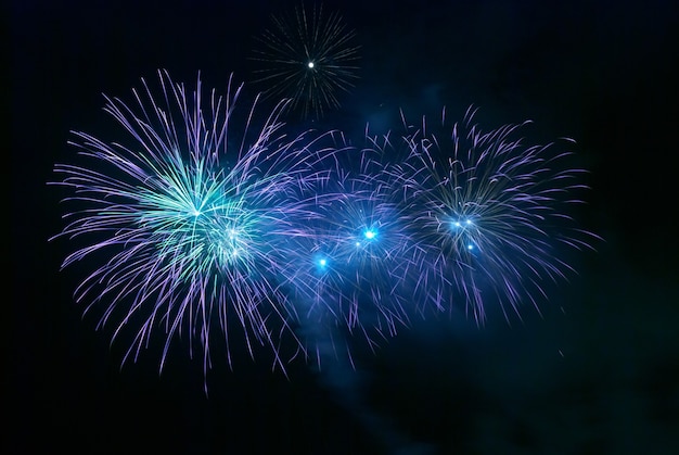 Blue fireworks on the black sky background