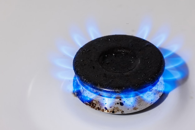 Photo the blue flame of the gas burner of the kitchen stove