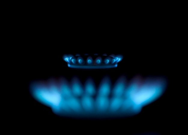 A blue flame is lit up in the dark