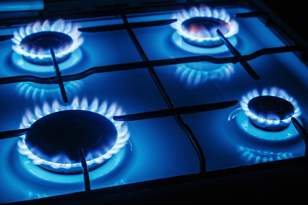 Photo blue flames of gas burning from a kitchen gas stove