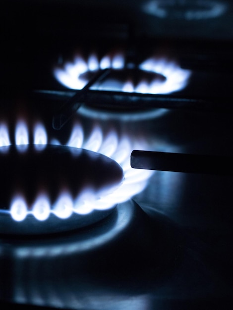 Blue flames of gas on a kitchen gas stove burner