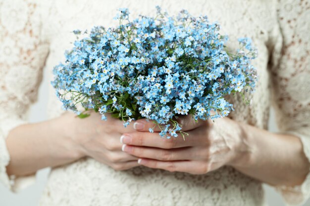 Blue flowers in female hands