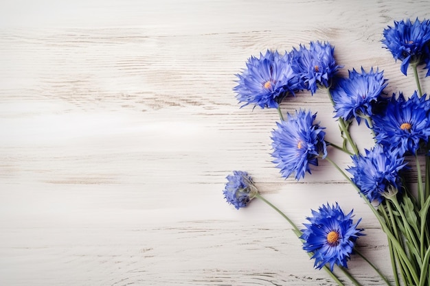 Blue flowers on a white wooden background