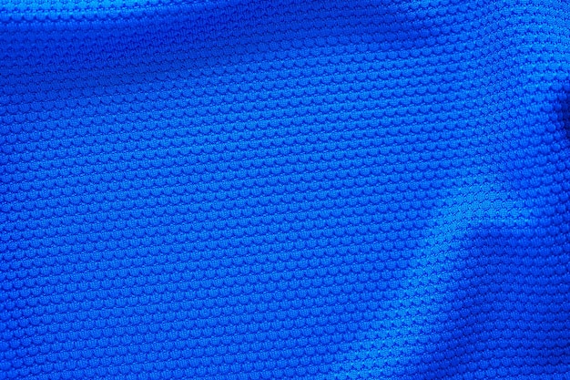 Blue football jersey clothing fabric texture sports wear background, close up top view