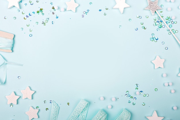 Blue Frame background with stylish decoration stars and sequins with copy space for text.  Flat lay, top view