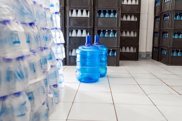 blue gallons of drinking water are stacked in the drinking water factory to cycle the drinking water