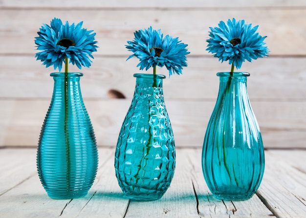 Blue gerbera flower in a vase on wooden