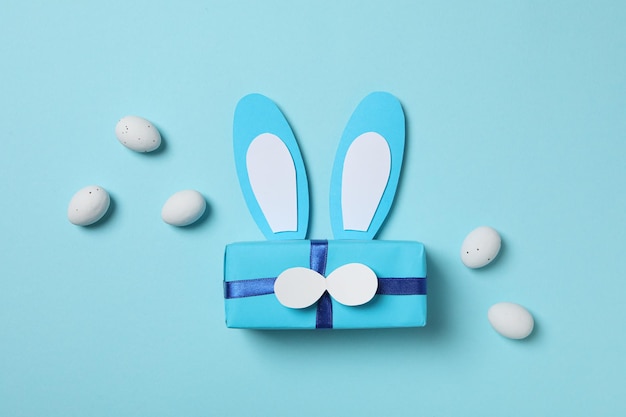 Blue gift box with bunny ears on a blue background