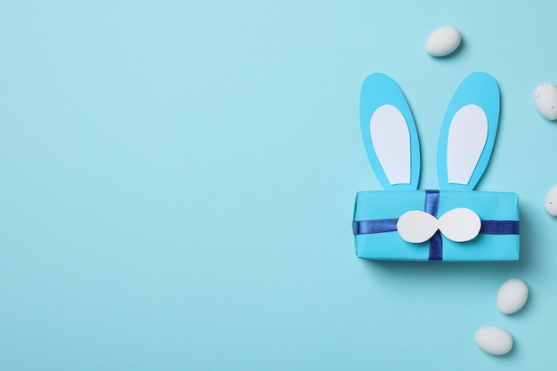 Blue gift box with bunny ears on a blue background