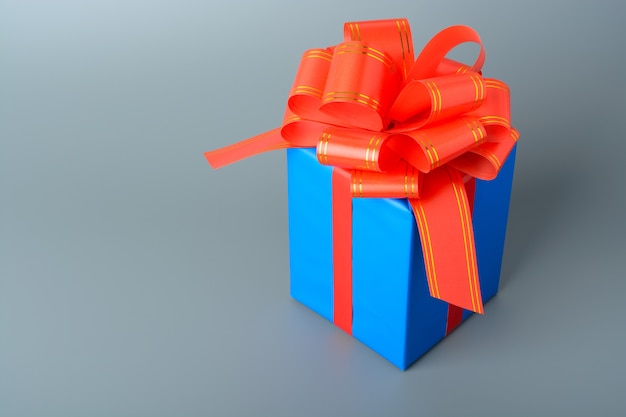 Blue gift box with red ribbon and bow