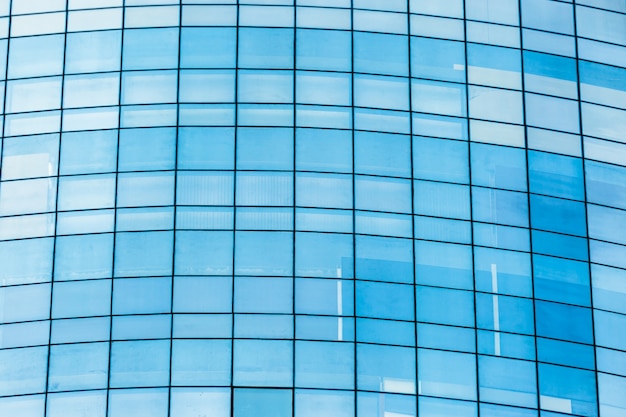 Blue glass windows of office building for background