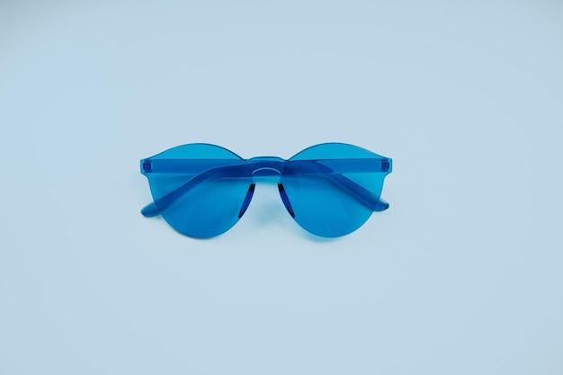 Blue glasses on a pastel blue background