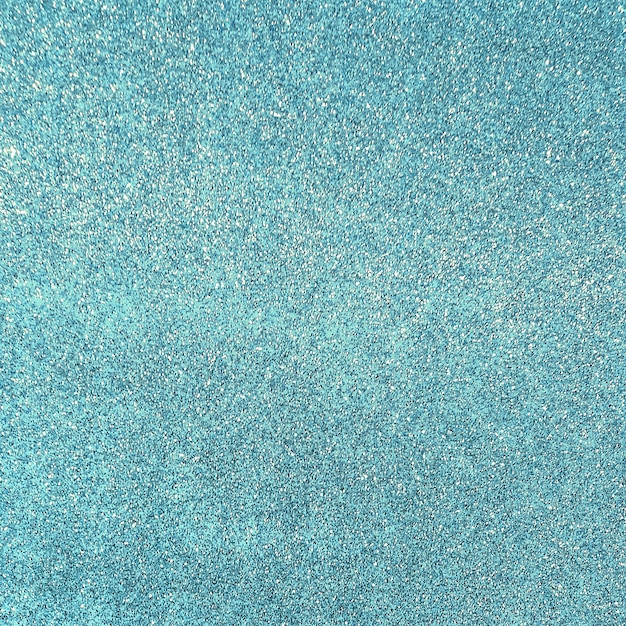 Photo blue glittering background with sparkles. blur