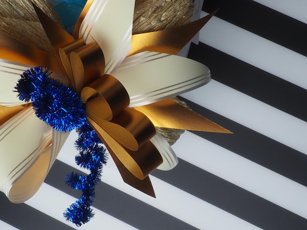 A blue and gold bow with gold ribbon and a blue ribbon