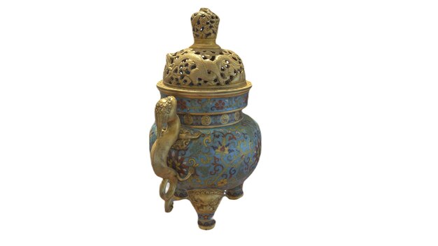 A blue and gold vase with a bird on it.