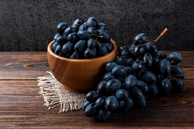 Blue grapes on dark wooden 