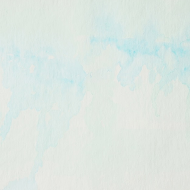 Pittura astratta blu e verde dell'acquerello strutturata sul fondo del libro bianco