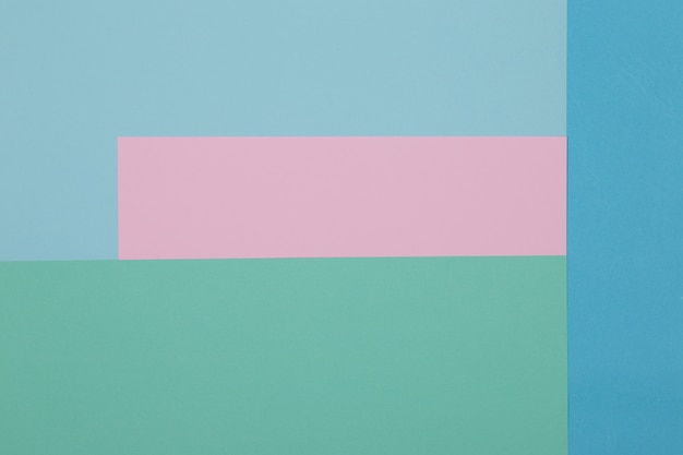 Blue, green and pink background, colored paper geometrically divides into zones, frame, copy, space.