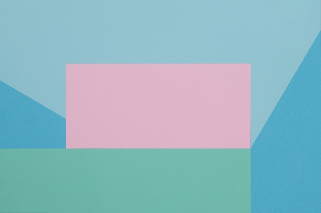 Blue, green and pink background, colored paper geometrically divides into zones, frame, copy, space.