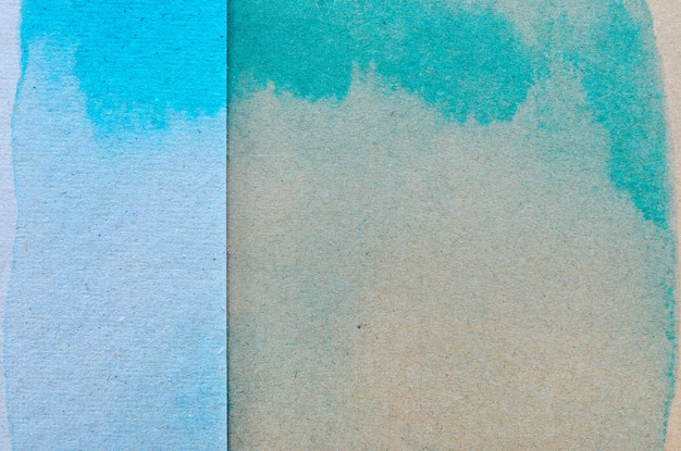 Photo blue and green watercolor on brown paper background