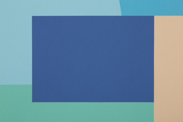 Blue, green, yellow background, colored paper geometrically divides into zones, frame, copy, space.