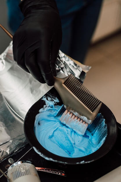 Blue hair dye in a hairdressers bowl