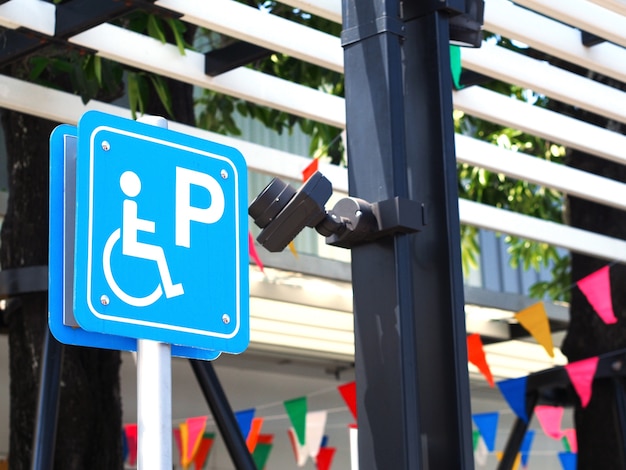 Photo blue handicapped parking sign at petrol station.