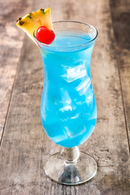 Blue Hawaiian cocktail on wooden table