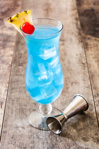 Blue Hawaiian cocktail on wooden table