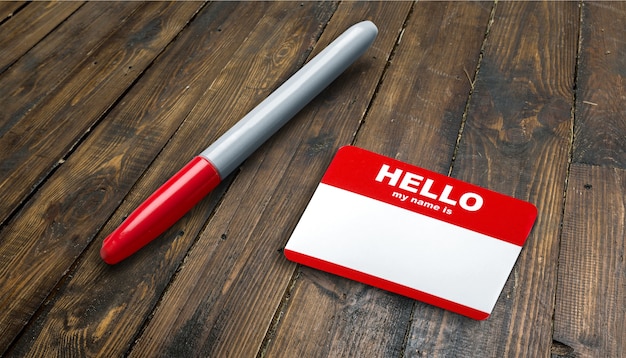 Blue Hello My Name Is Tag and pen on table with Copy Space