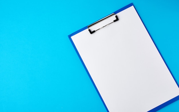 Blue holder with clean white sheets on a blue background