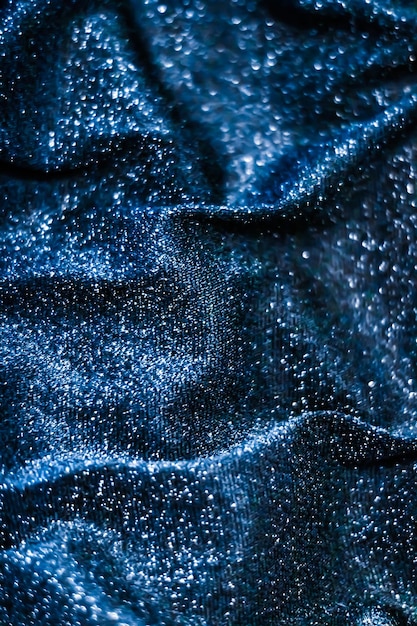 Blue holiday sparkling glitter abstract background luxury shiny fabric material for glamour design and festive invitation