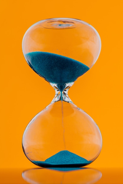 Blue hourglass on a yellow background