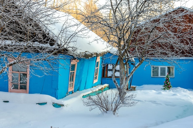 A blue house in the snow with the word no on the front.