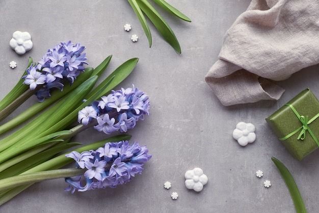 Blue hyacinth flowers on light stone background, top view