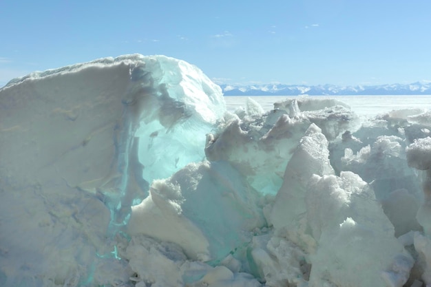 Blue ice clear transparent hummocks on the frozen lake